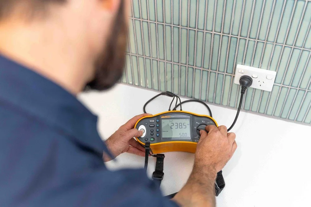 Certified electrician performing electrical safety inspection
