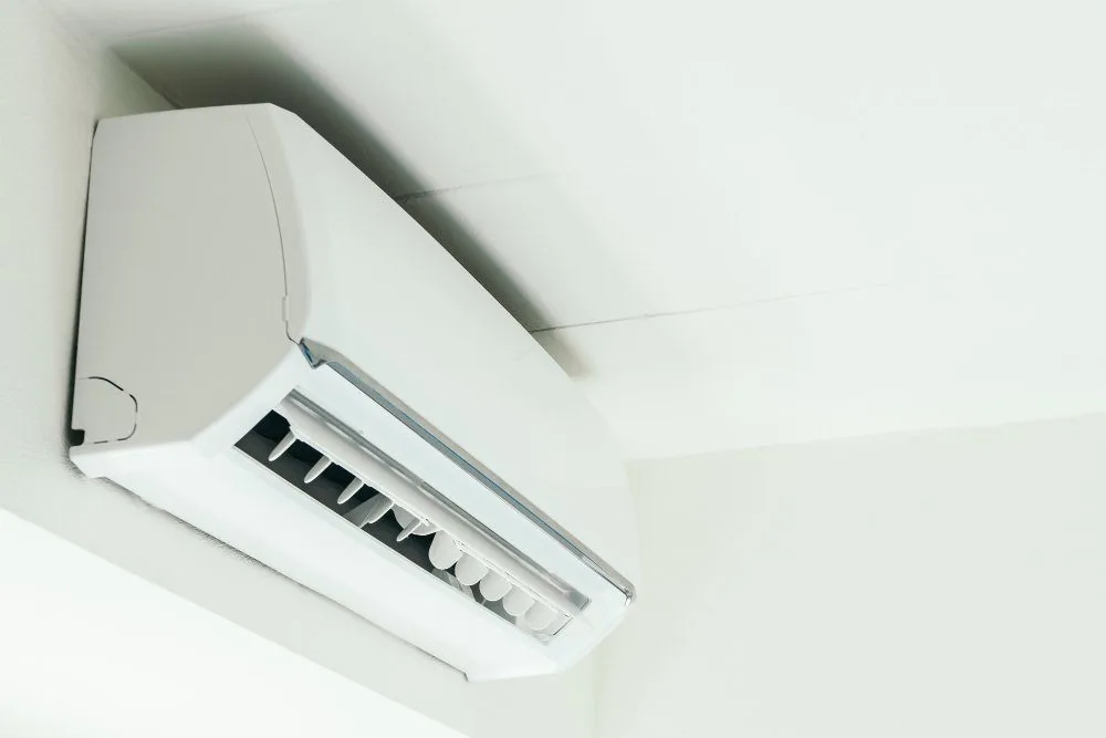 Licensed electrician performing air conditioning maintenance