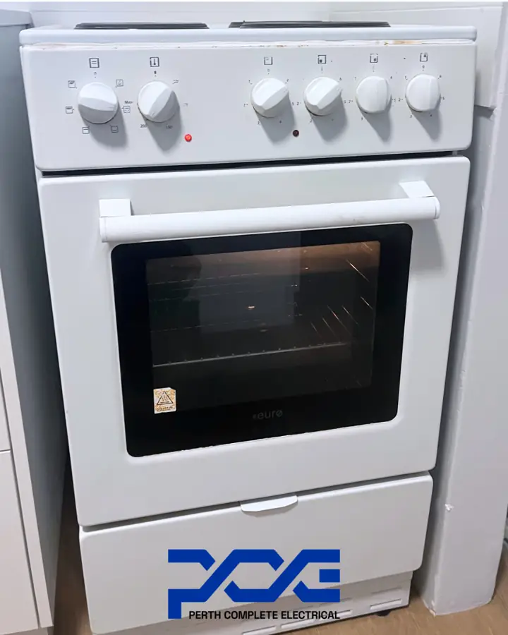 White freestanding electric stove in a Yokine kitchen after Perth Complete Electrical upgraded the circuit protection and installed a hob isolation switch